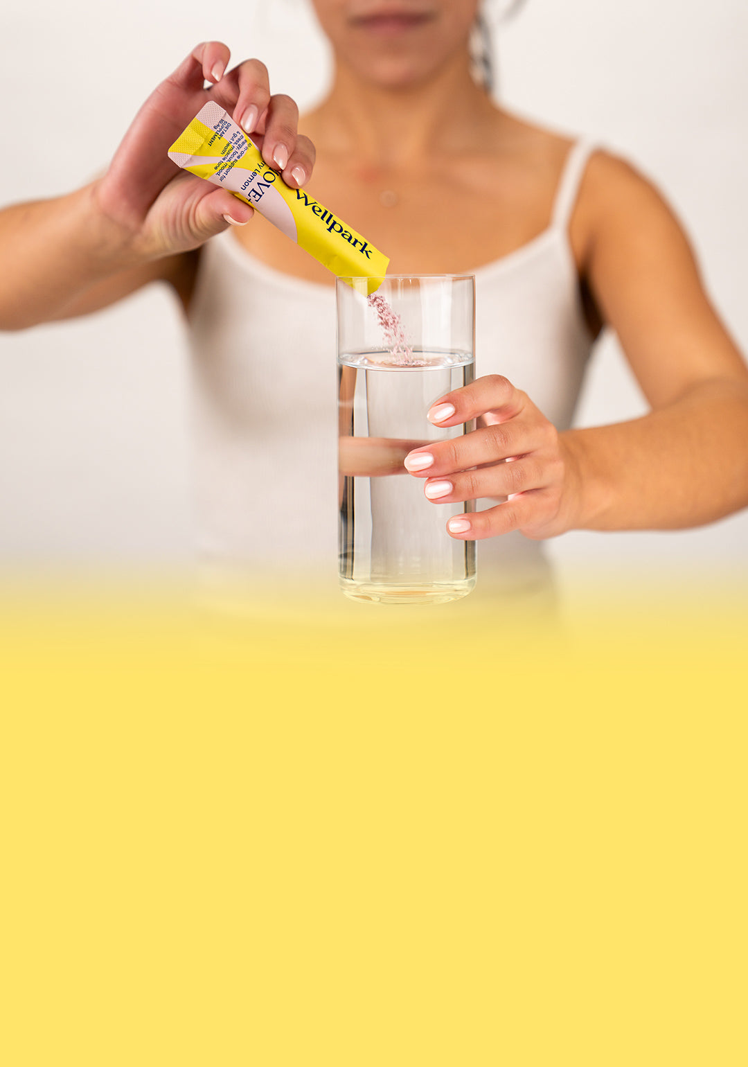 Woman pouring MOVE+ sachet into a glass