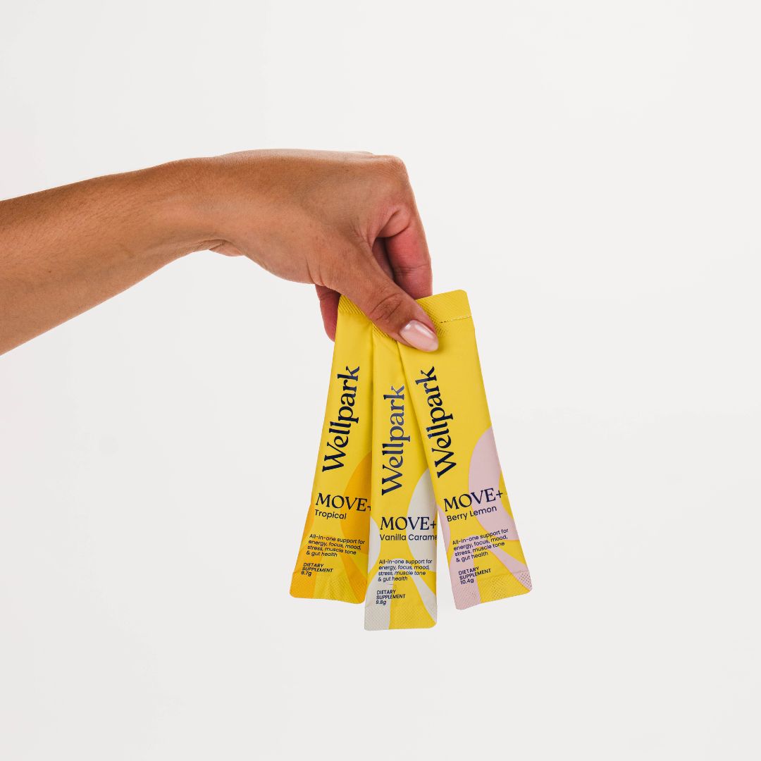 Hand holding three Wellpark MOVE+ sachets